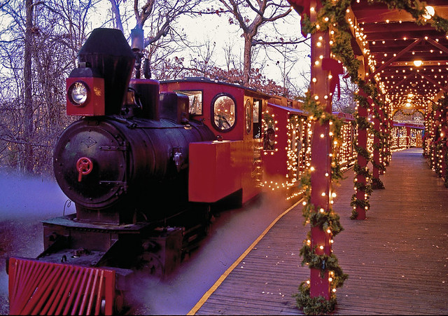 Old-fashioned train decorated with Christmas lights at Silver Dollar City in Branson, Missouri, during the holiday season.