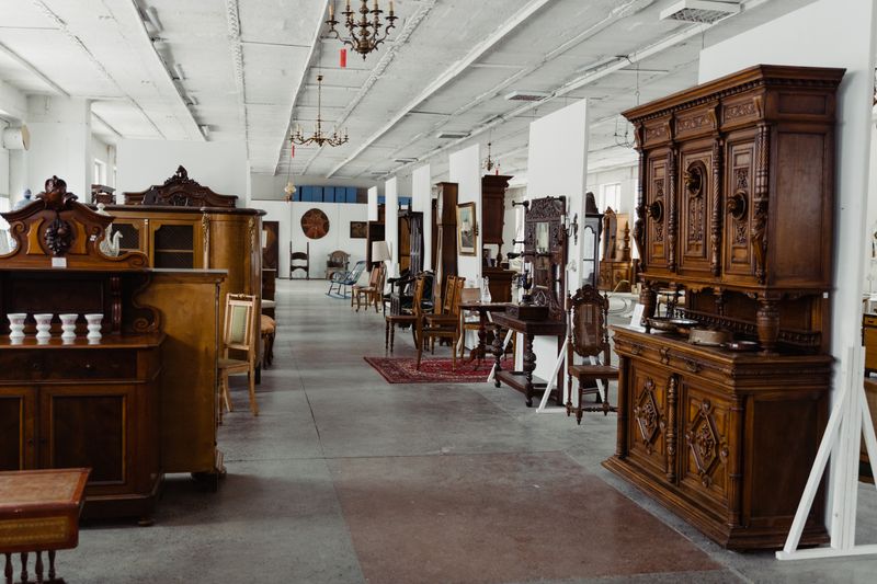 Antique wooden furniture filling the large showroom at Apple Tree Mall in Branson