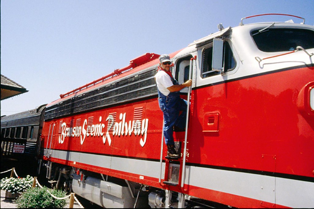 Branson Scenic Railway engineer boarding the red locomotive at the historic downtown Branson depot