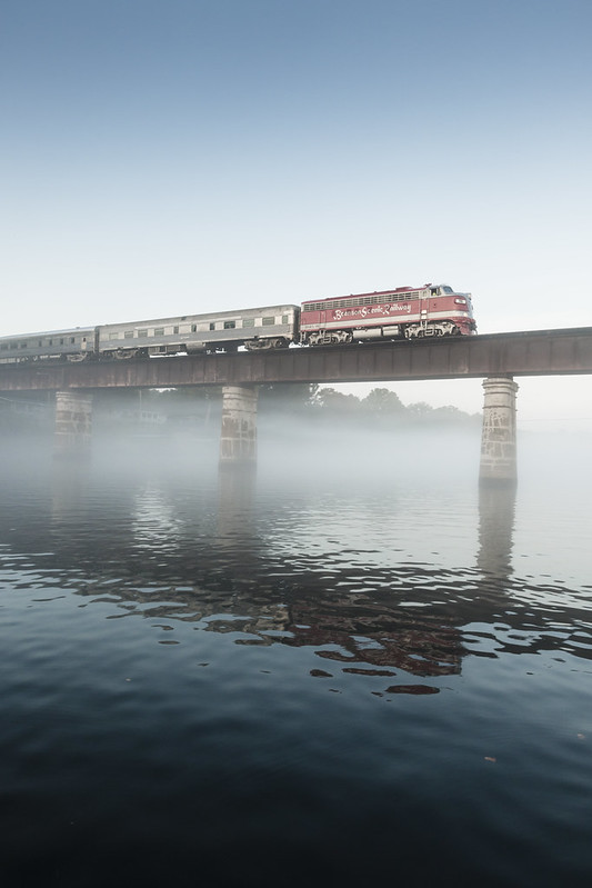 Branson Scenic Railway train crossing a bridge over the White River Valley on a misty morning in Missouri