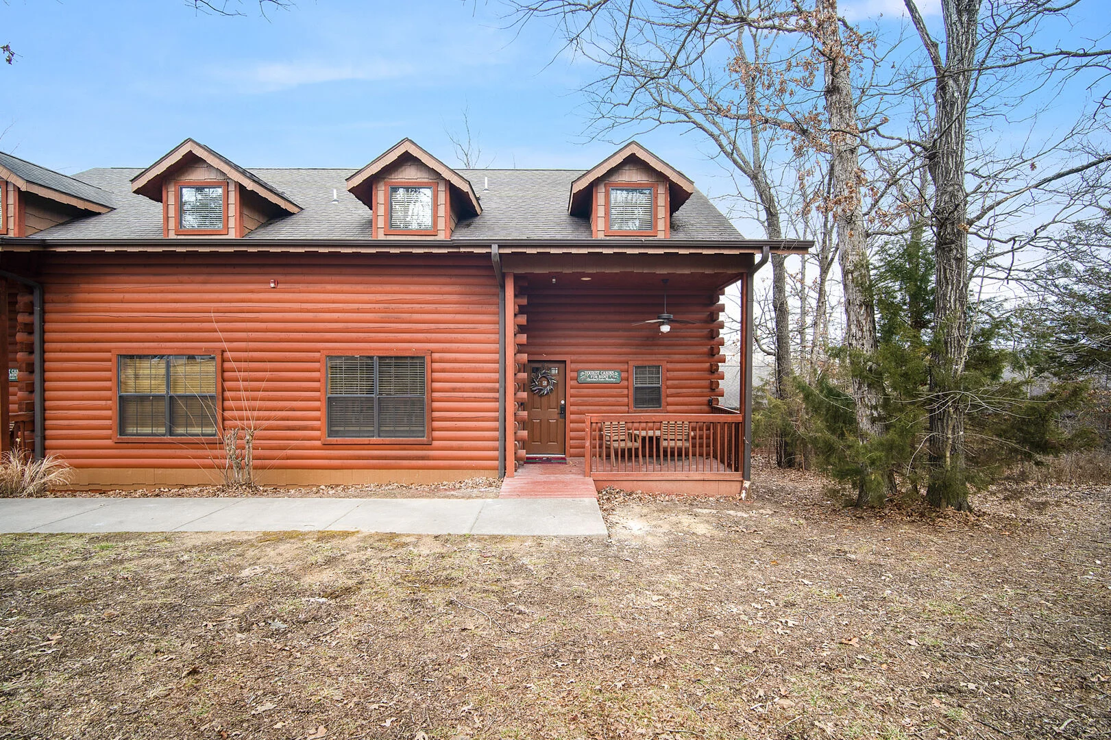 Exterior of a Thousand Hills Vacations log cabin rental in Branson Missouri with covered porch suited for America 250 vacation stays