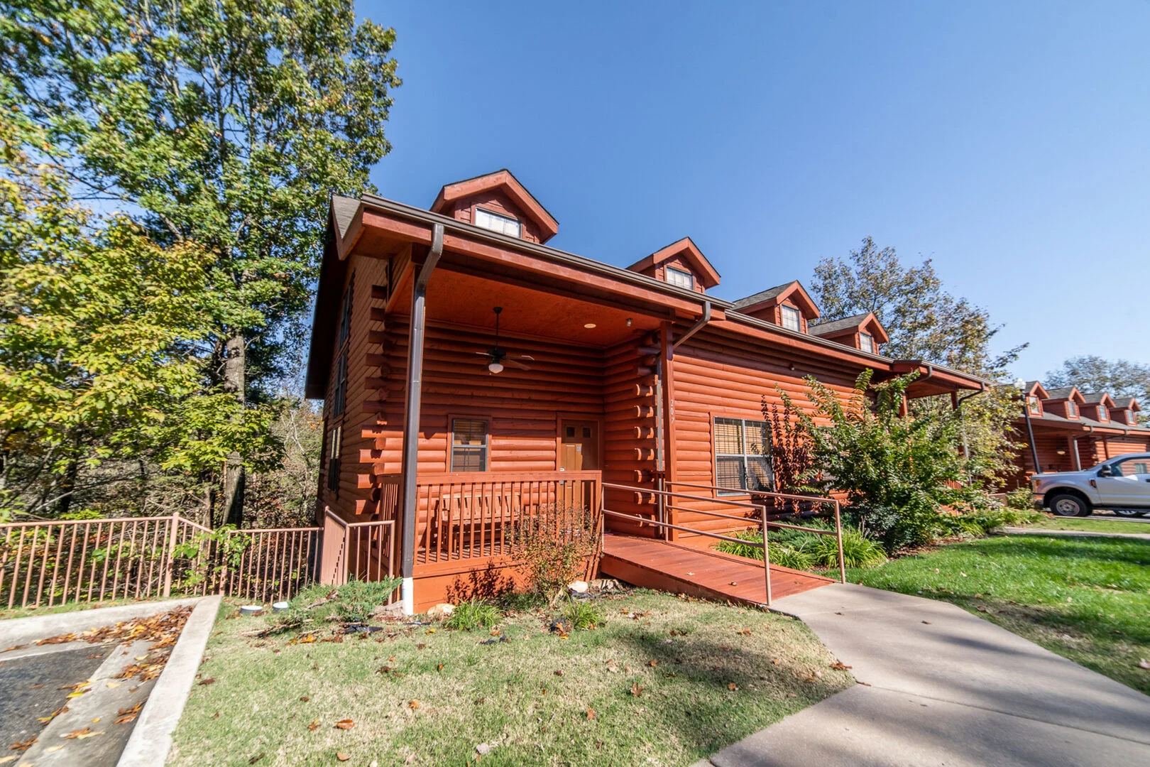 Log cabin rental with covered front porch near Table Rock Lake, a popular Branson birthday getaway stay
