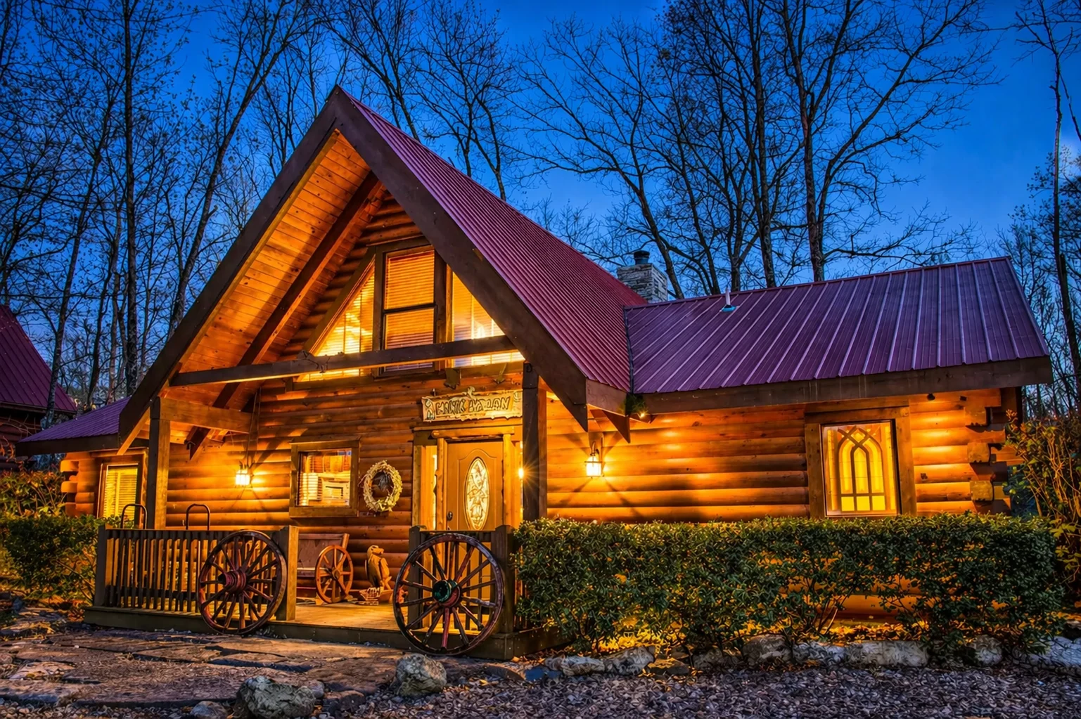 A-frame log cabin exterior with wagon wheel accents in the Branson Cedars neighborhood, Ridgedale, Missouri