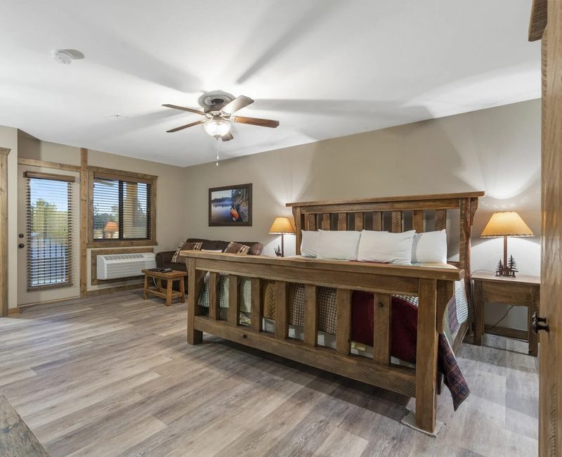 Rustic king bedroom in a Branson lodge rental with room for grandparents and grandkids on the same trip