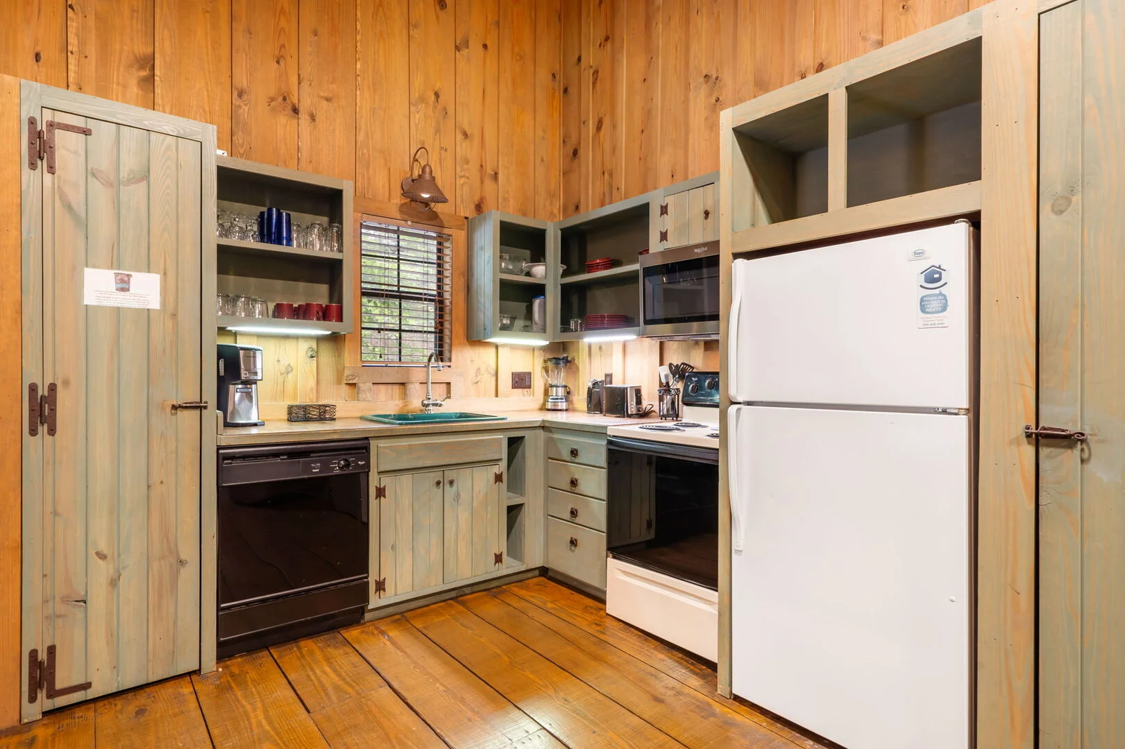 Full kitchen inside a Cabins at Green Mountain log cabin, a Thousand Hills Vacations rental in Branson, Missouri