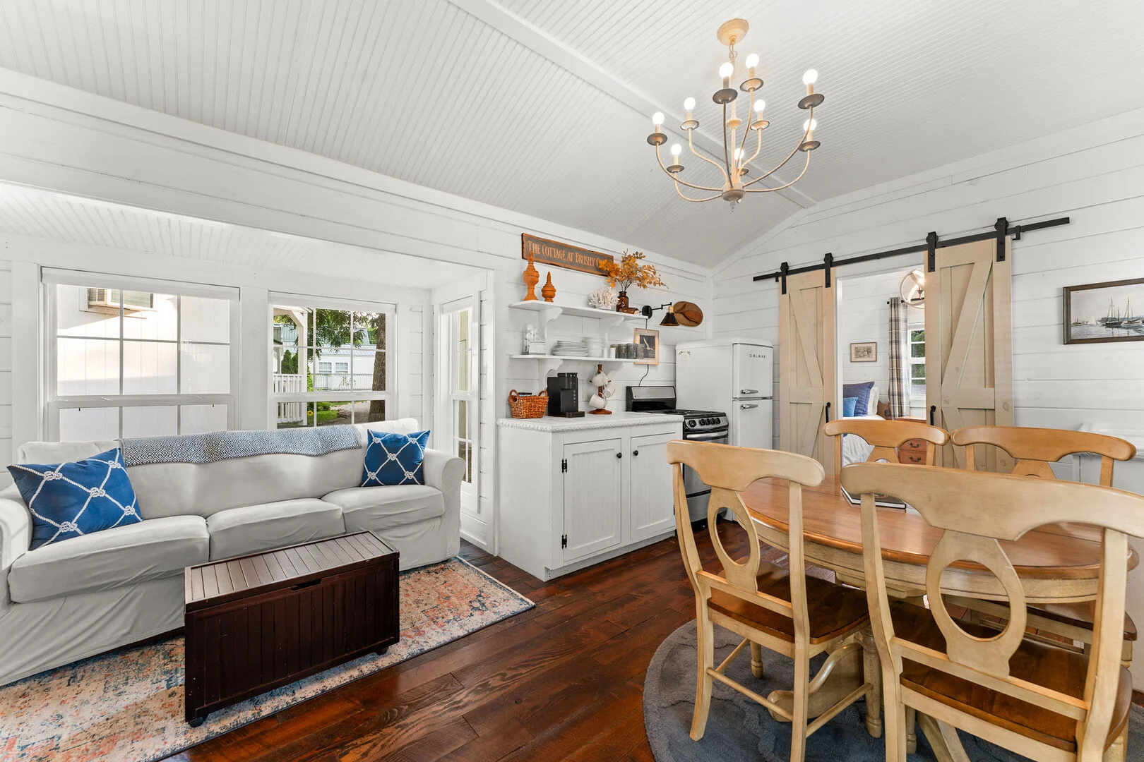 Open living room, kitchen and dining table inside The Family Hideaway, the two-bedroom unit at Cottages at Brushy Creek near Branson, Missouri