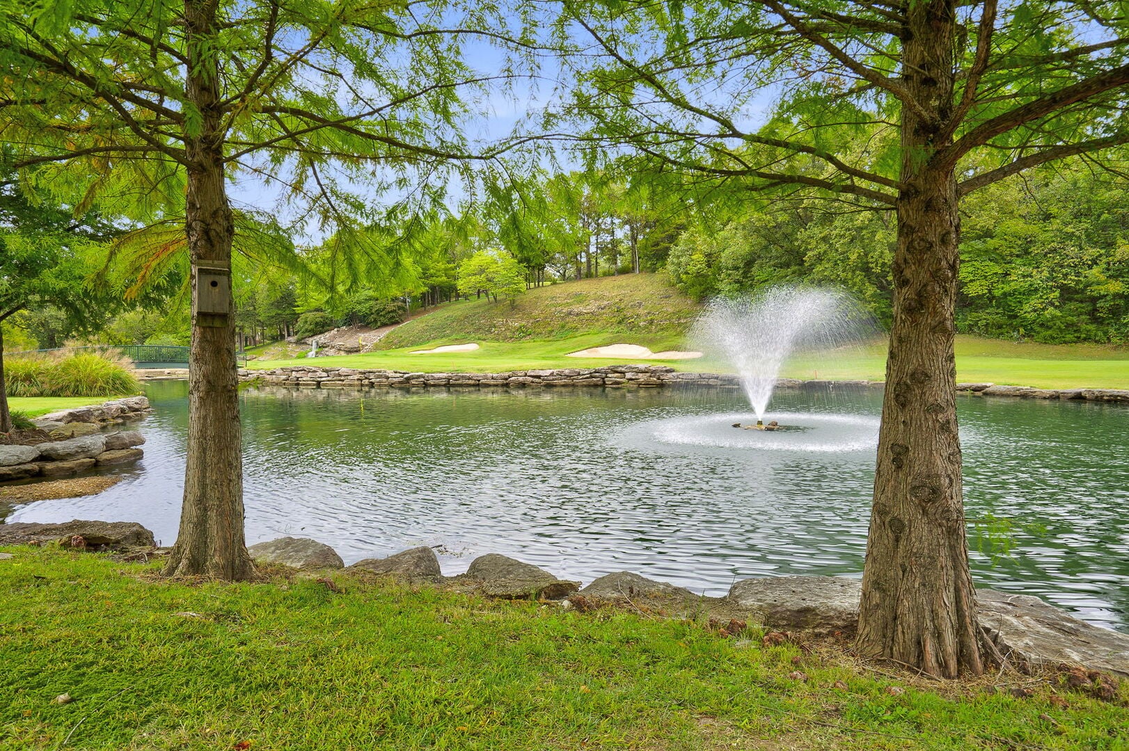 Fountain pond and fairway at LedgeStone golf course inside StoneBridge Village Resort near Branson, Missouri