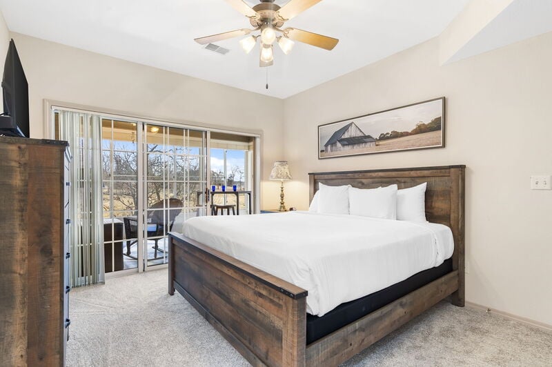 King bedroom with private balcony access in a Legacy at Thousand Hills condo rental near Highway 76 in Branson, Missouri