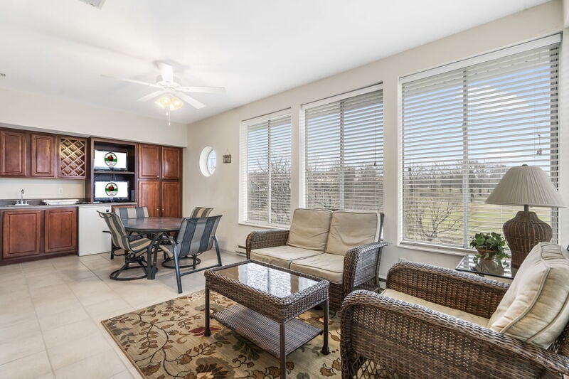 Sunroom seating area with wet bar in a three-bedroom Legacy at Thousand Hills golf condo in Branson, Missouri