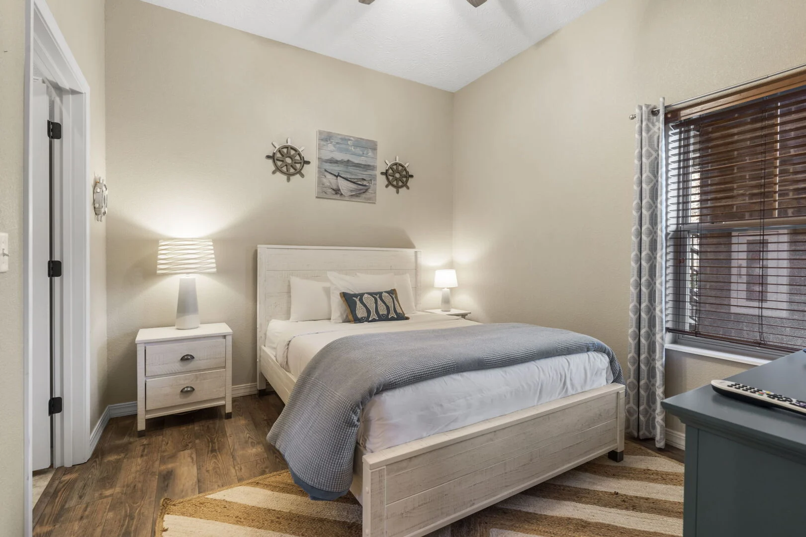 Guest bedroom with a queen bed and nautical decor in a Majestic at Table Rock condo near Table Rock Lake