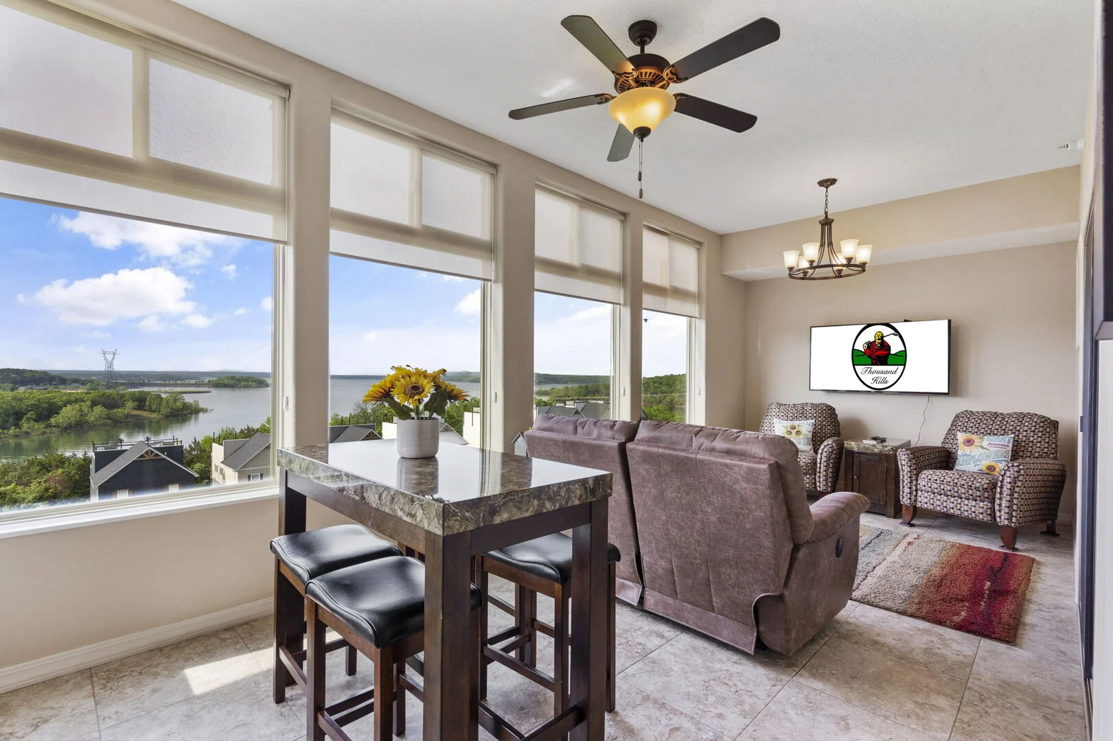 Sunroom living area with tall windows overlooking Table Rock Lake in a Majestic at Table Rock condo in Branson, Missouri