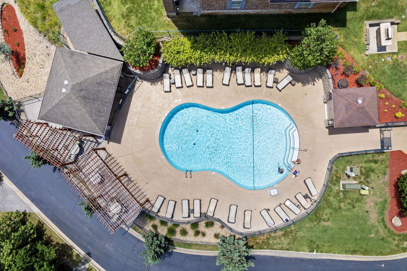 Aerial view of the seasonal outdoor pool and lounge-chair deck at Majestic at Table Rock Lake in Branson