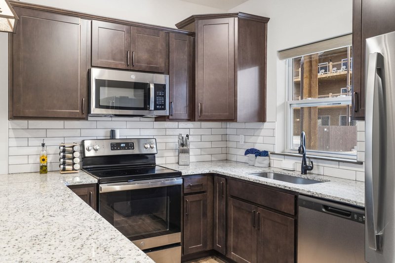Full kitchen with granite counters and stainless appliances in a Wilderness Mountain lodge near Branson